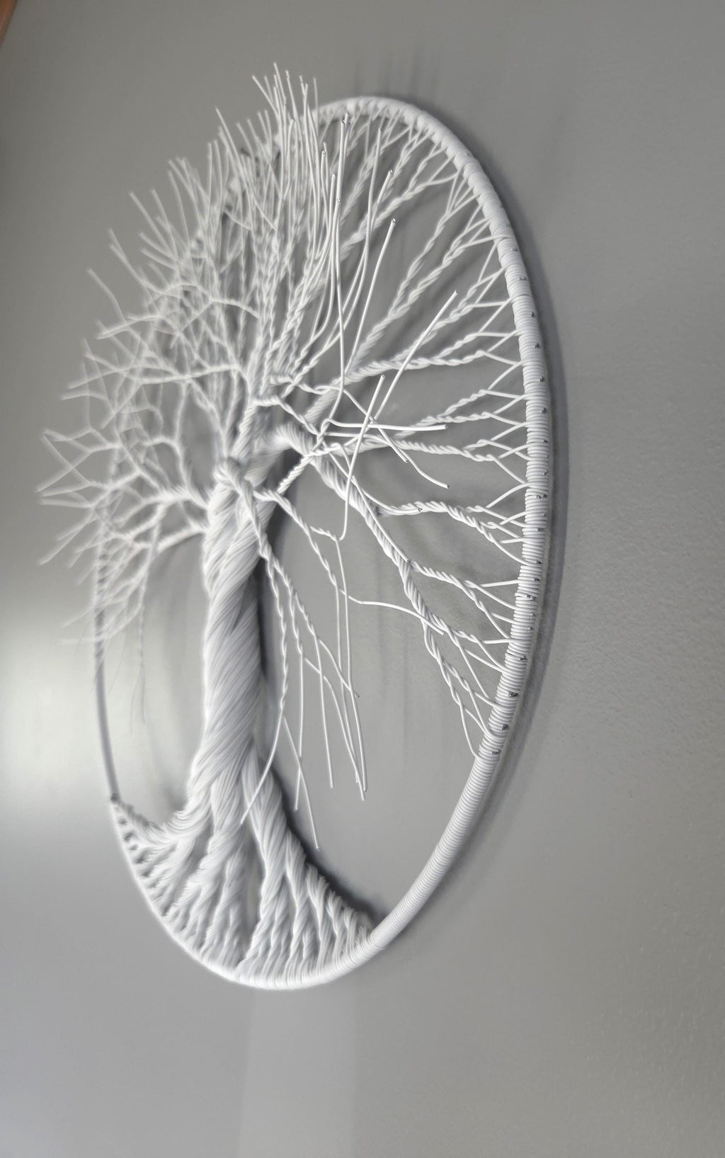 Decorative wall art of a tree with intricate branches on a gray background