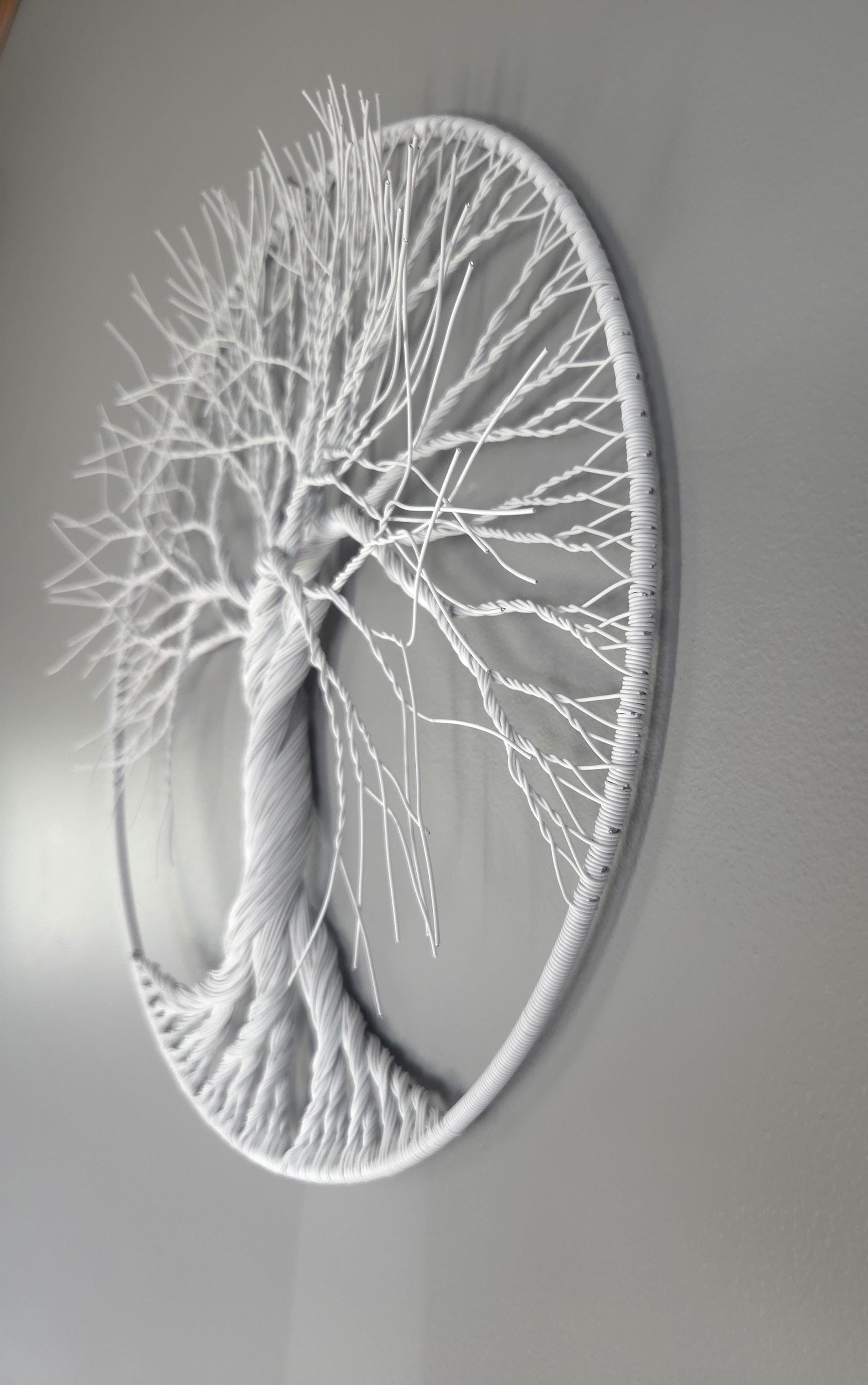 Decorative wall art of a tree with intricate branches on a gray background