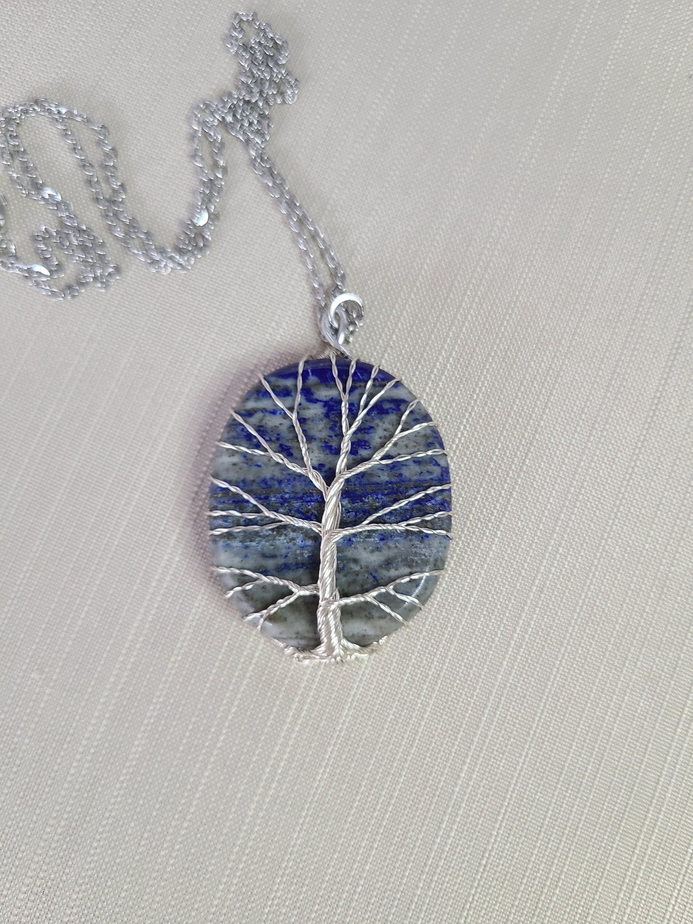 Necklace with a tree-shaped pendant on a light gray background