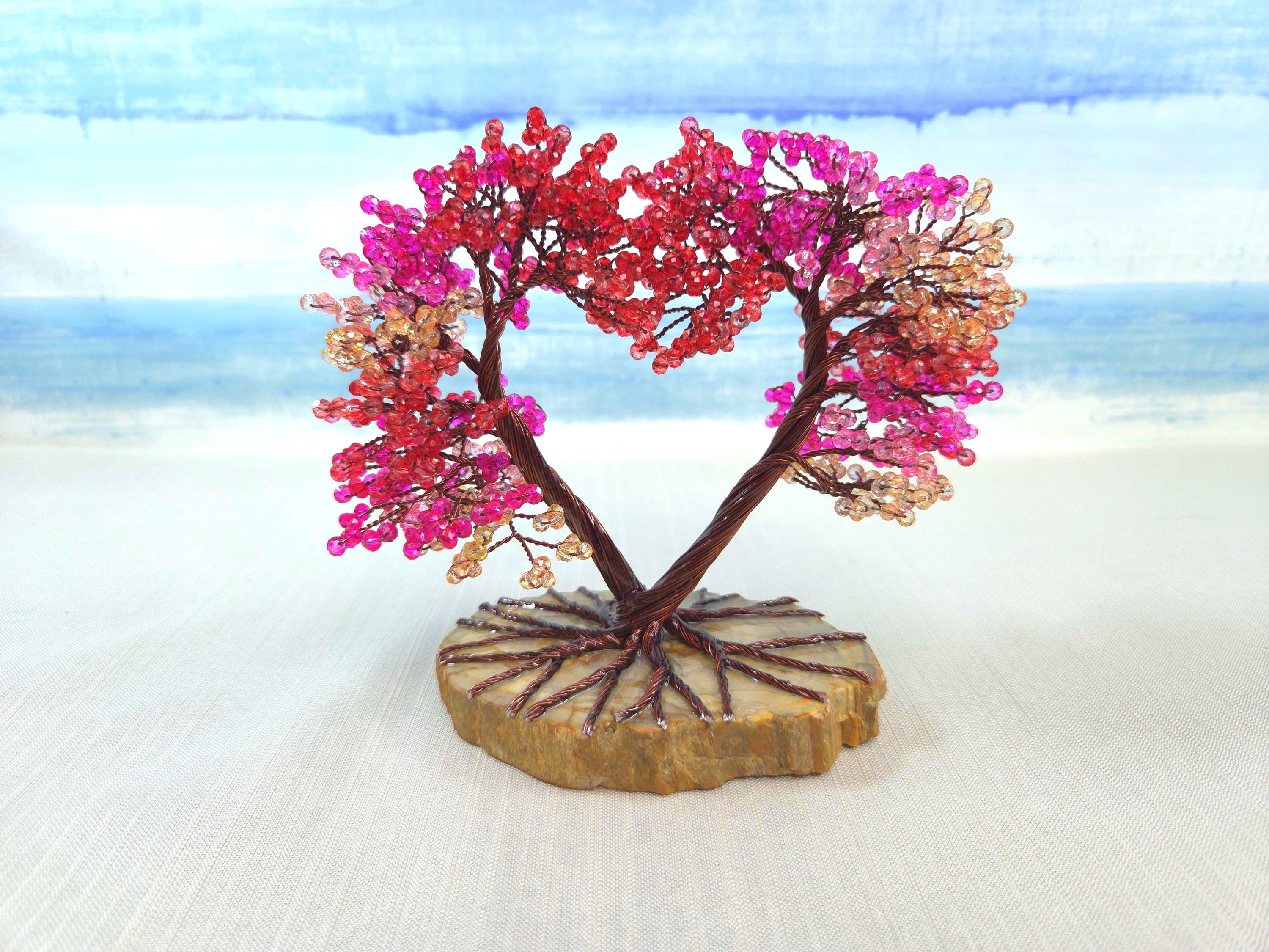 Decorative tree made of beads on a stone base with a blue sky background