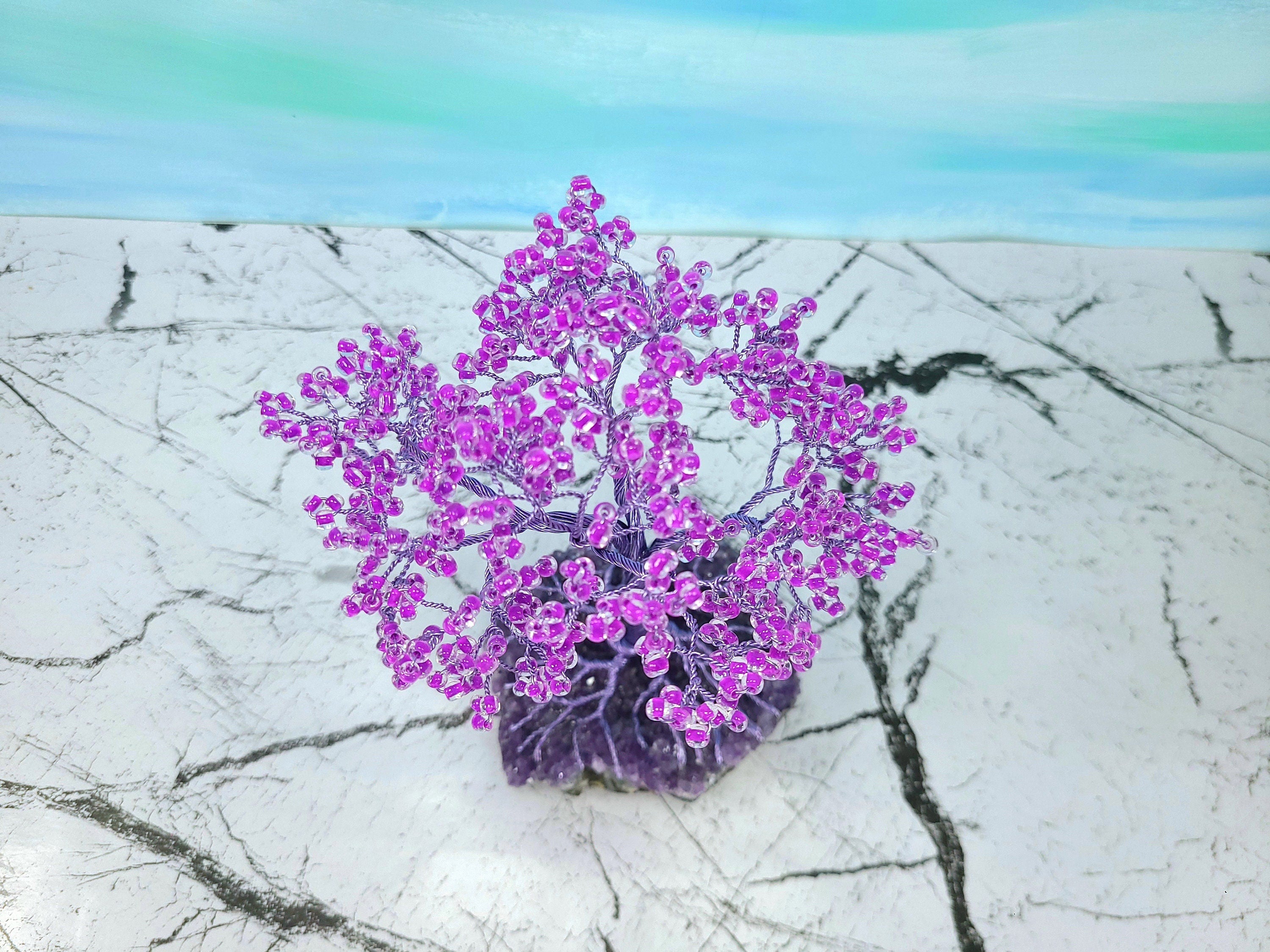 Purple tree-like structure on a textured white surface with a gradient blue background