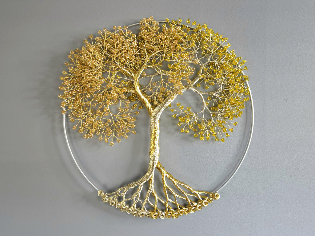 Decorative wall art of a gold tree with yellow leaves on a gray background
