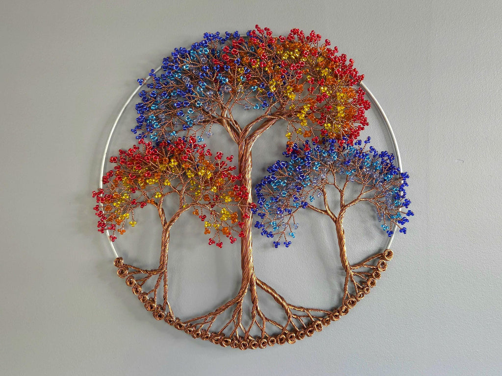 Decorative wall art of a tree with colorful leaves on a plain background