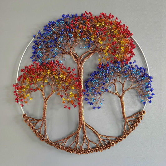 Decorative wall art of a tree with colorful leaves on a plain background